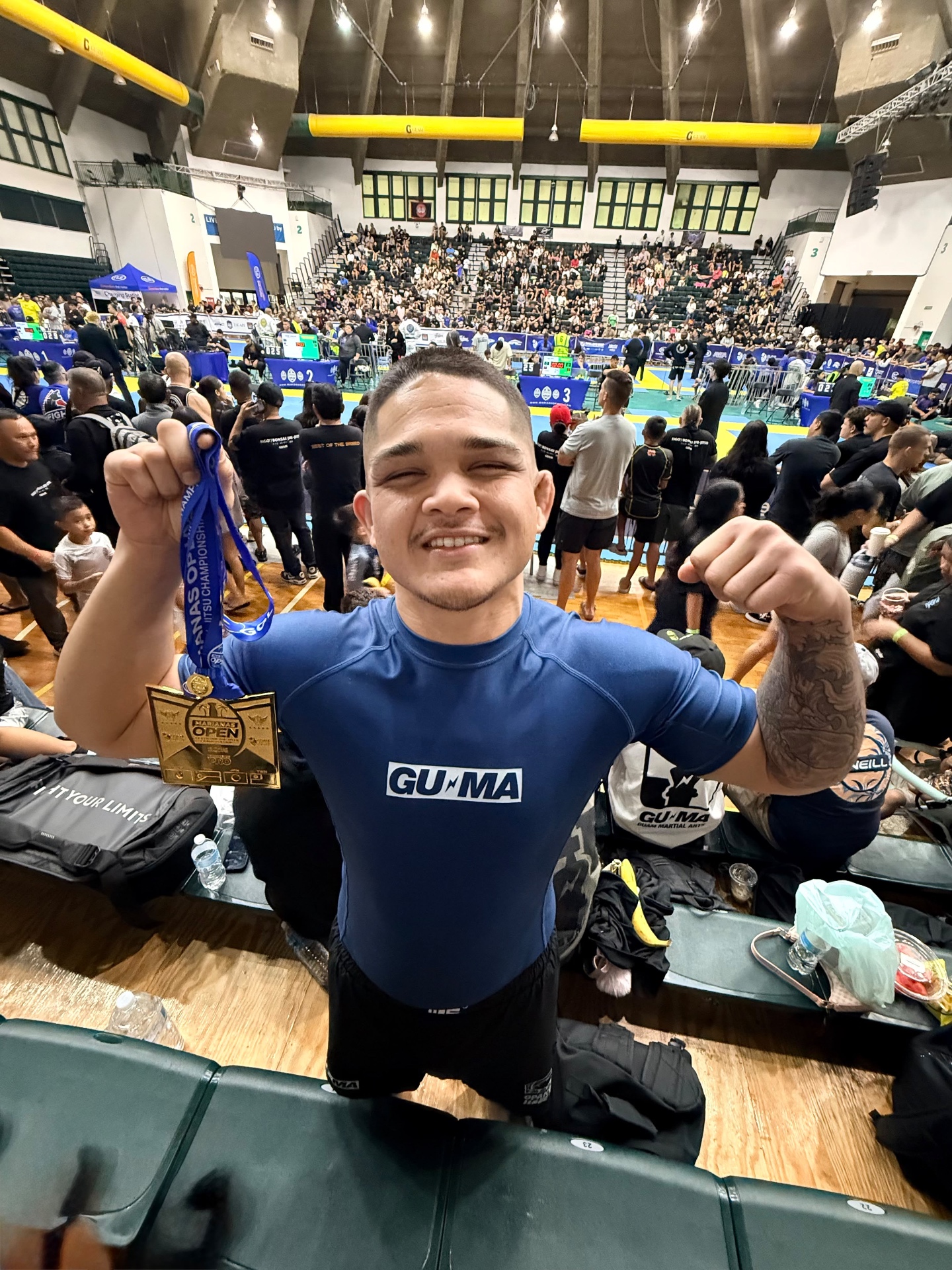 Coach Gabe celebrating with his 2025 Marianas Open medal