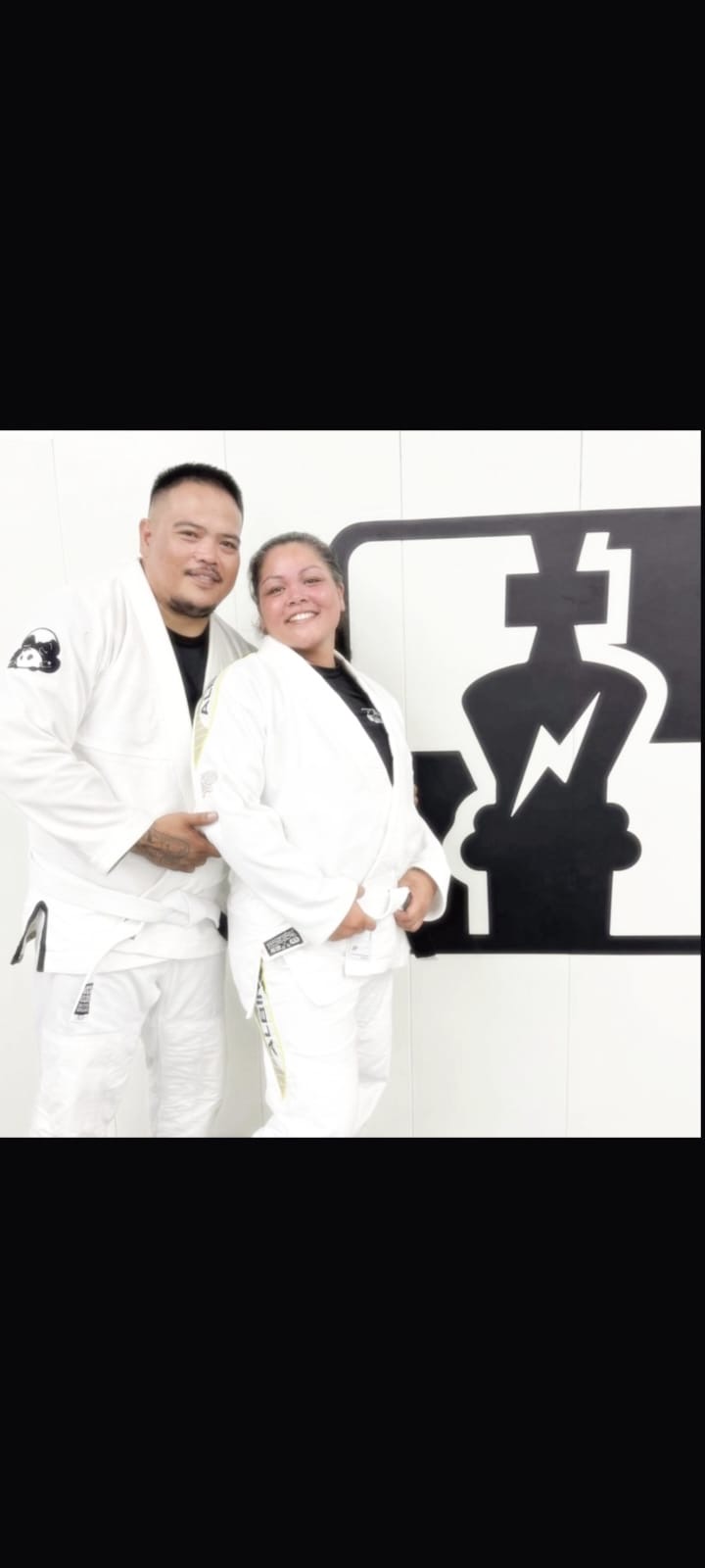 Travis John Salas with his wife on the mats in their gis