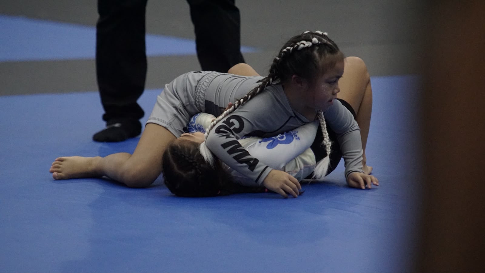 Ivy Sablan on top during a match in her grey GUMA rashguard