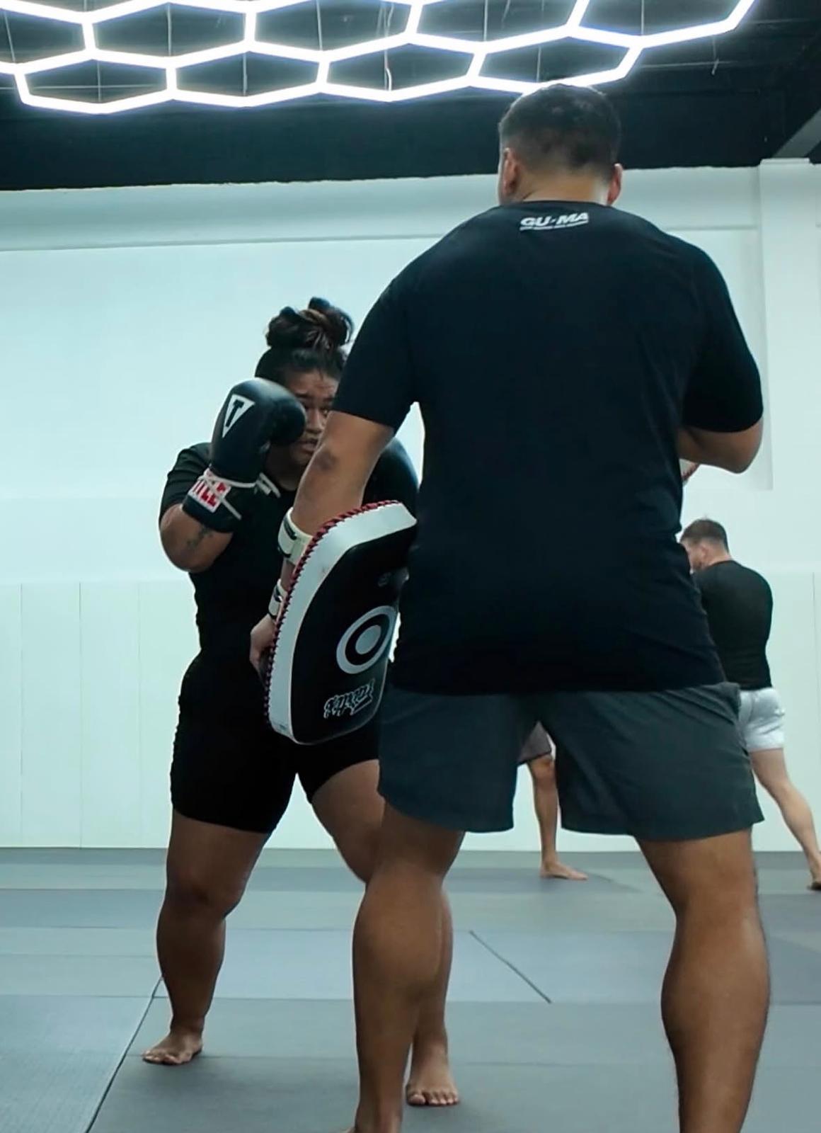 Desireé Vasquez working striking pads at GUMA