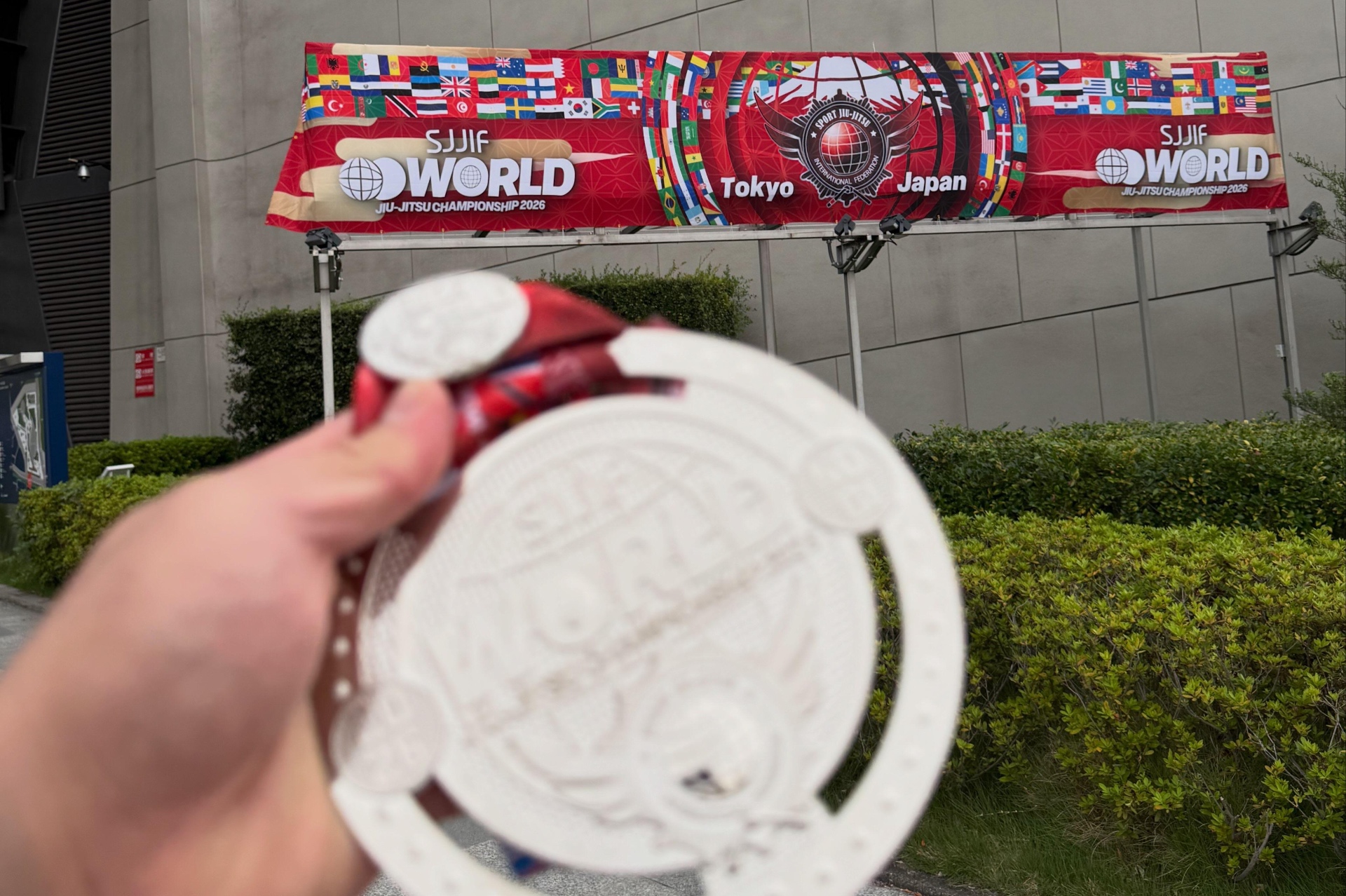 Coach Gabe holding his SJJIF World Championship medal