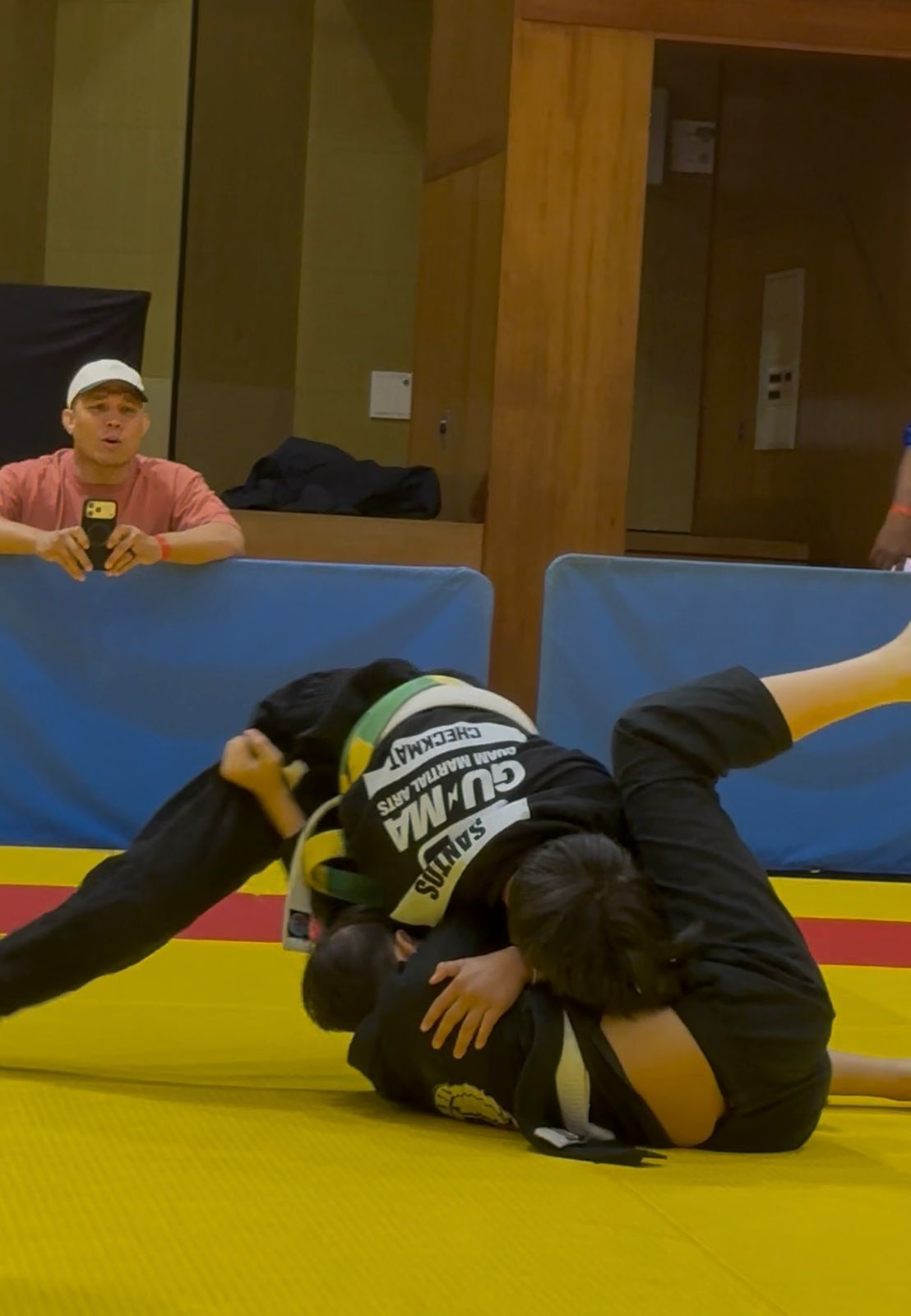Bray competing on the yellow mats in a GUMA rashguard