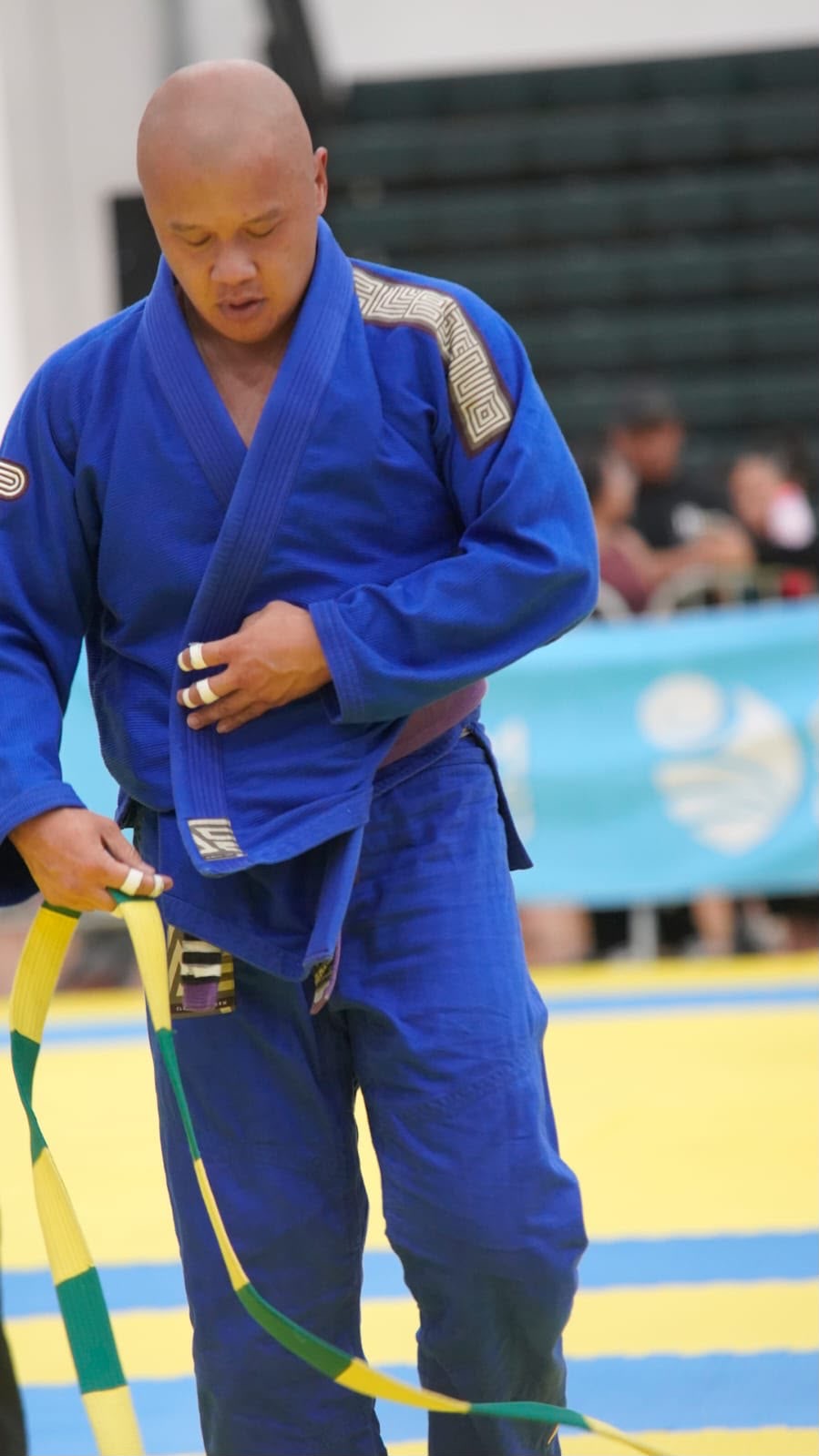 Richard Pilarca preparing to compete in his blue gi