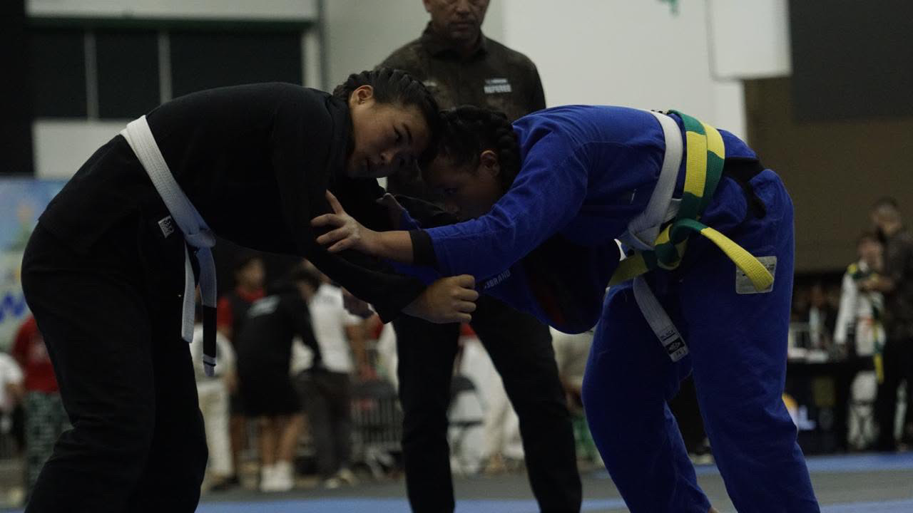Sophia Miranda in a black gi tied up in a standing exchange
