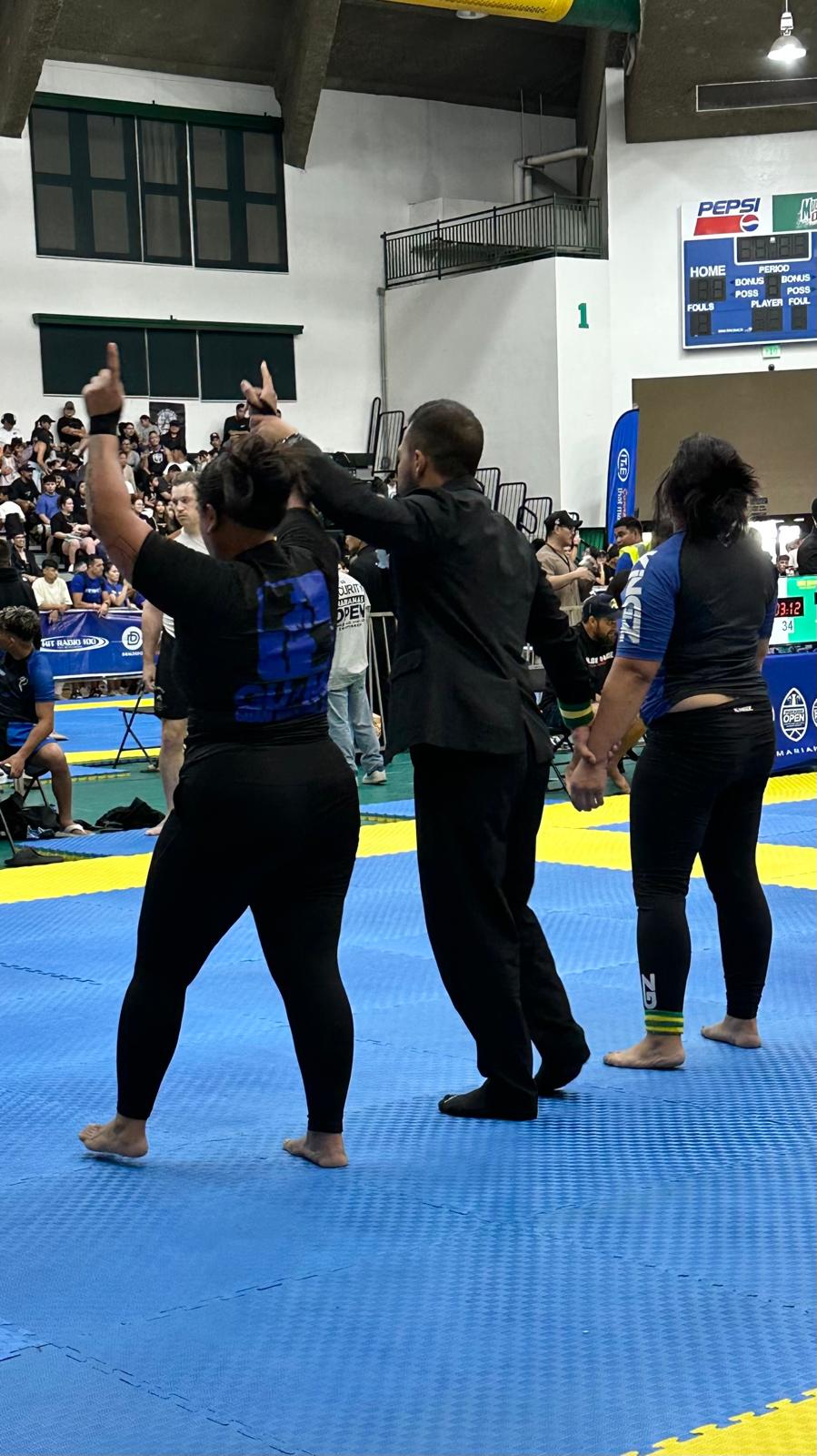 Desireé Vasquez getting her hand raised at a local tournament