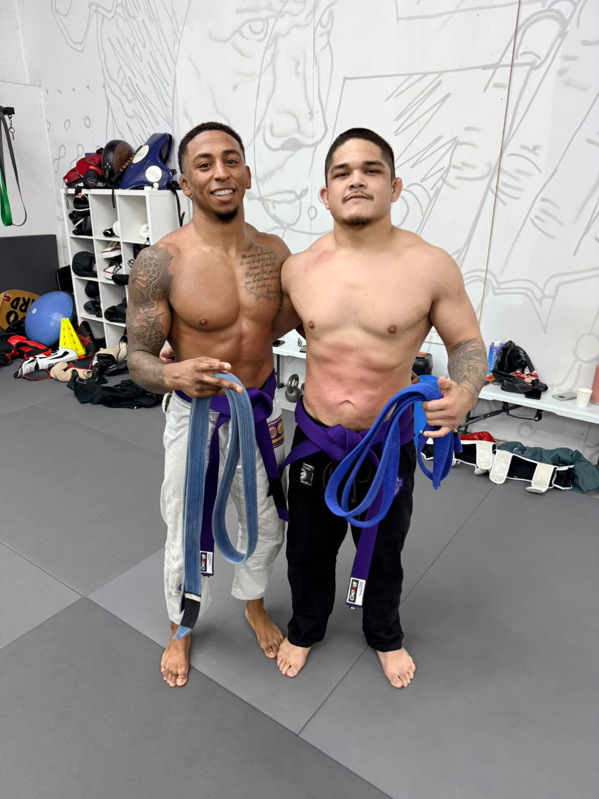 Brendan Sanders with a teammate and their belts