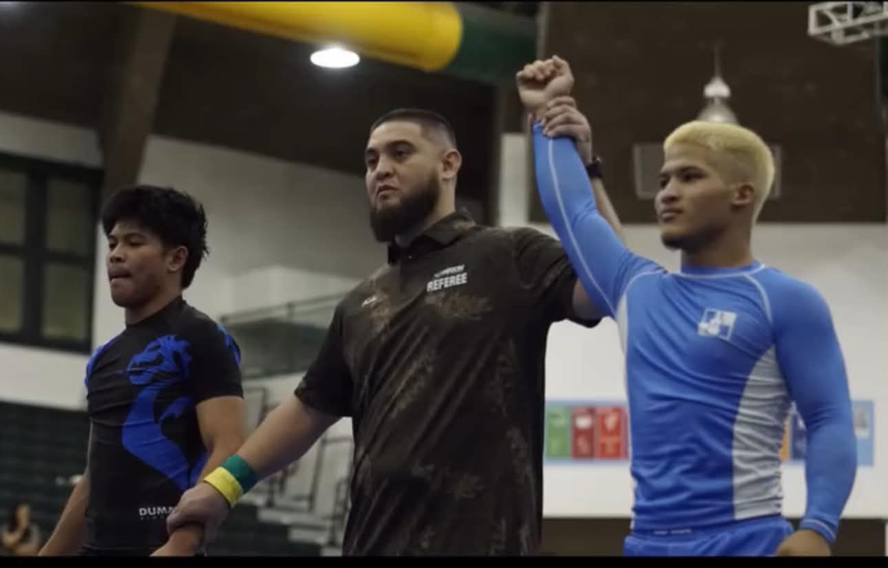 EthanRay Paulino having his hand raised after a competition win