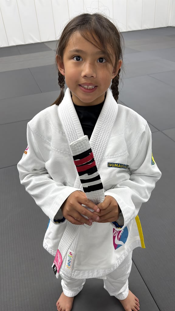 Summer Miranda showing her white belt stripes in her gi