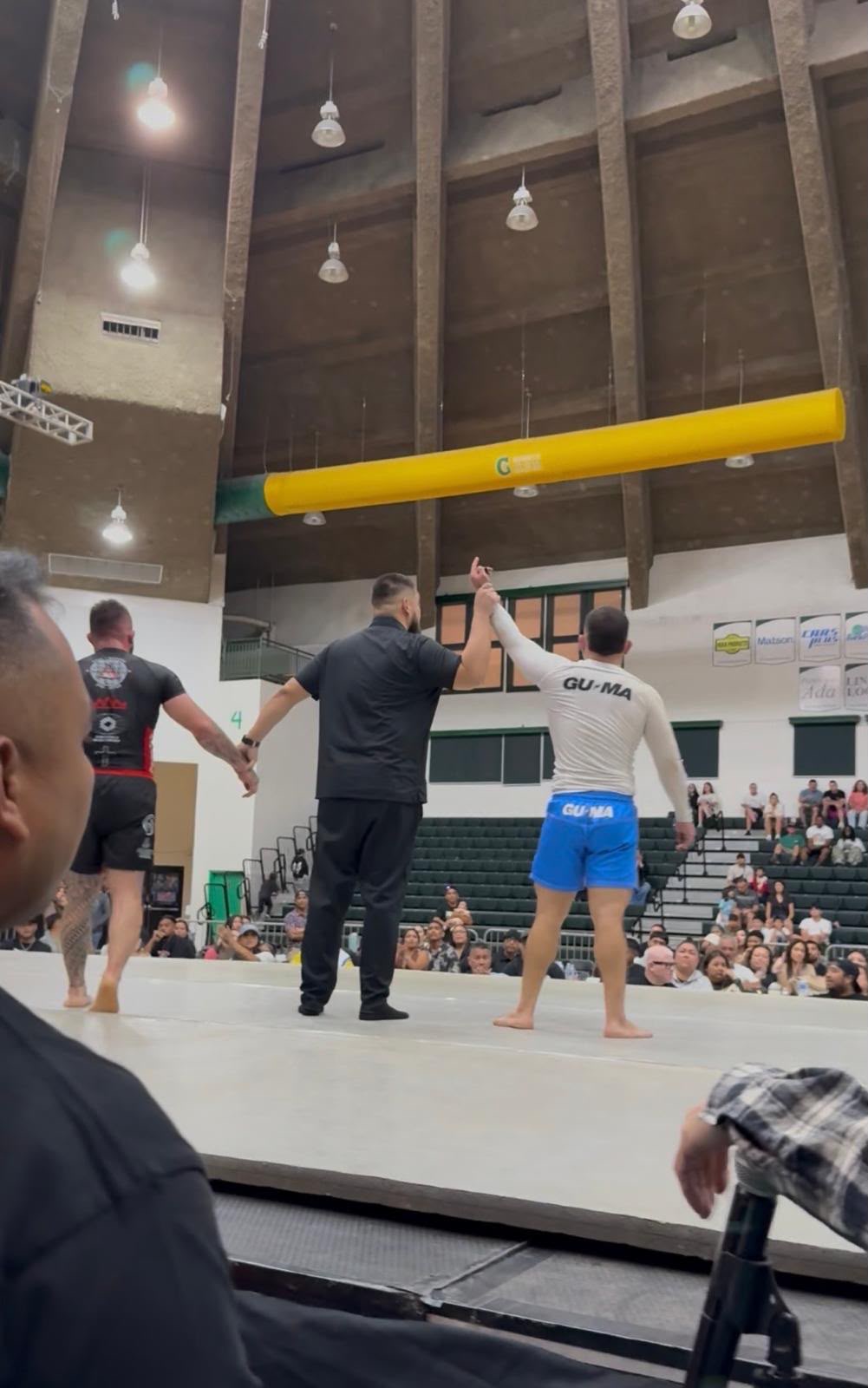 Coach Gabe having his hand raised at the Marianas Open