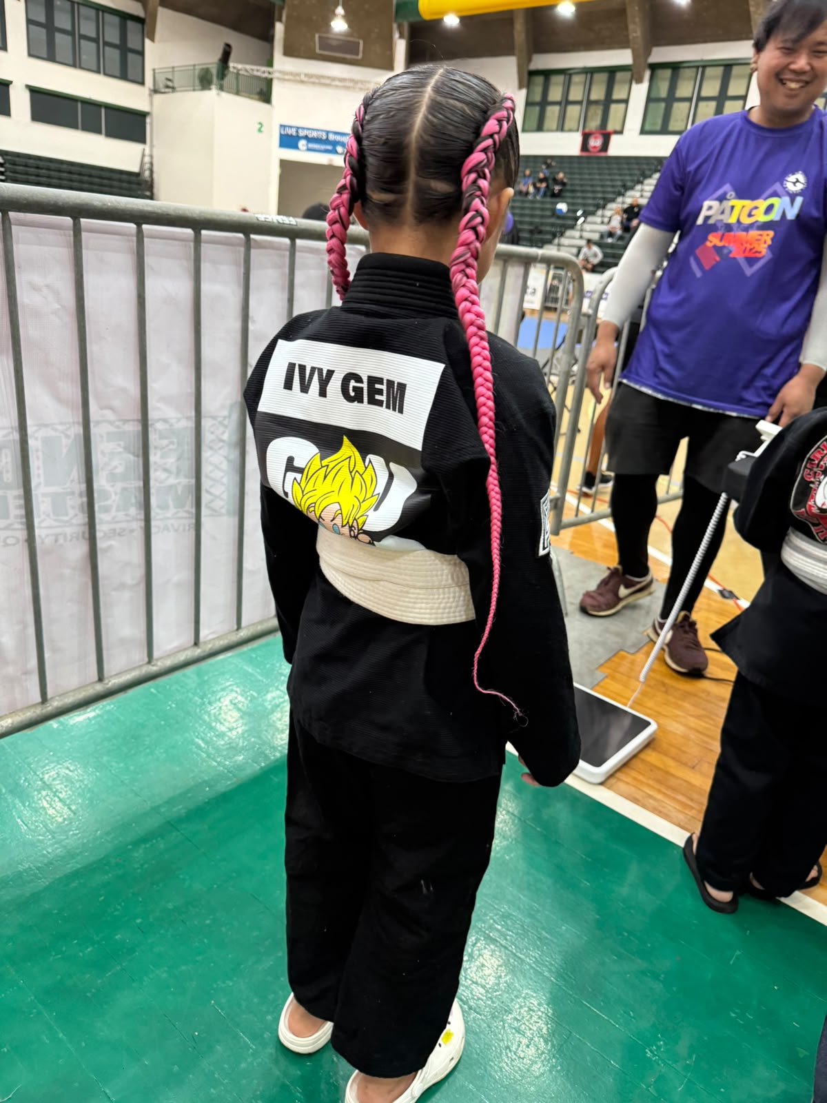 Ivy Sablan from behind showing her GUMA gi patch and 'IVY GEM' name